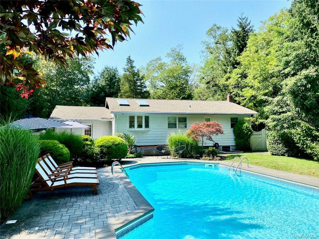 a view of a house with swimming pool and sitting area