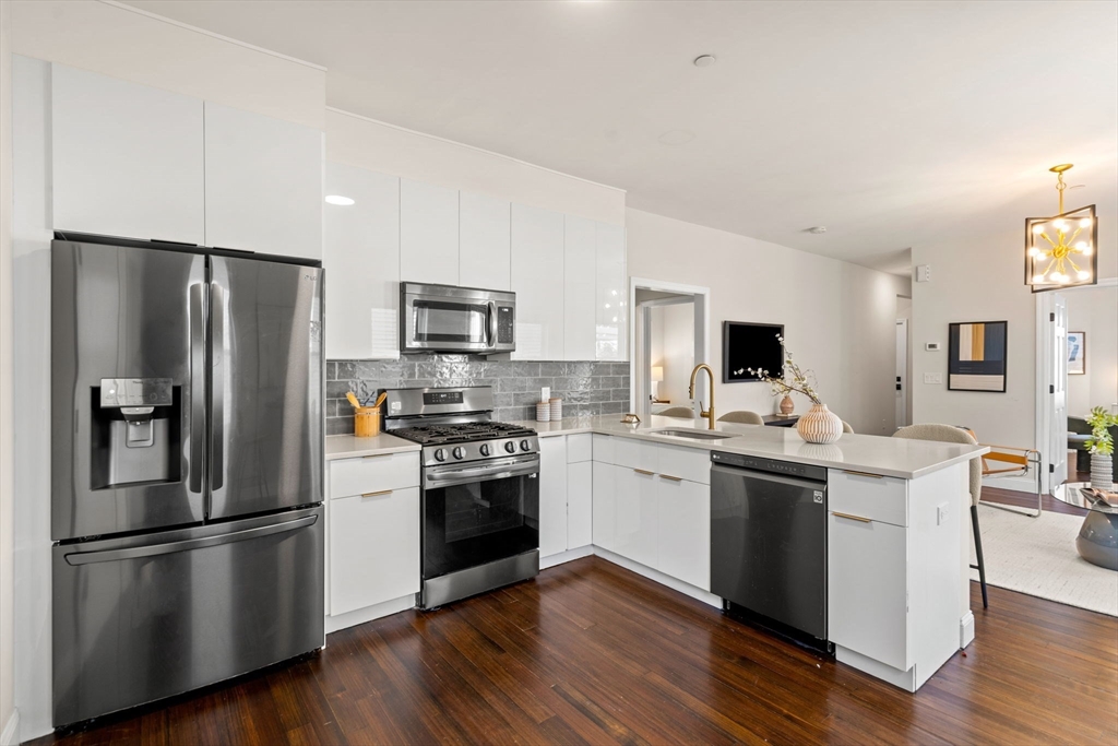 a kitchen with stainless steel appliances a refrigerator sink and stove