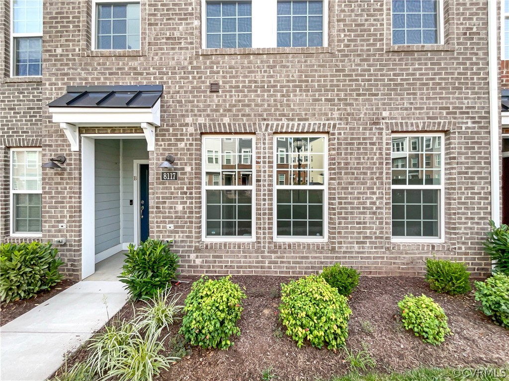 a front view of a brick house many windows