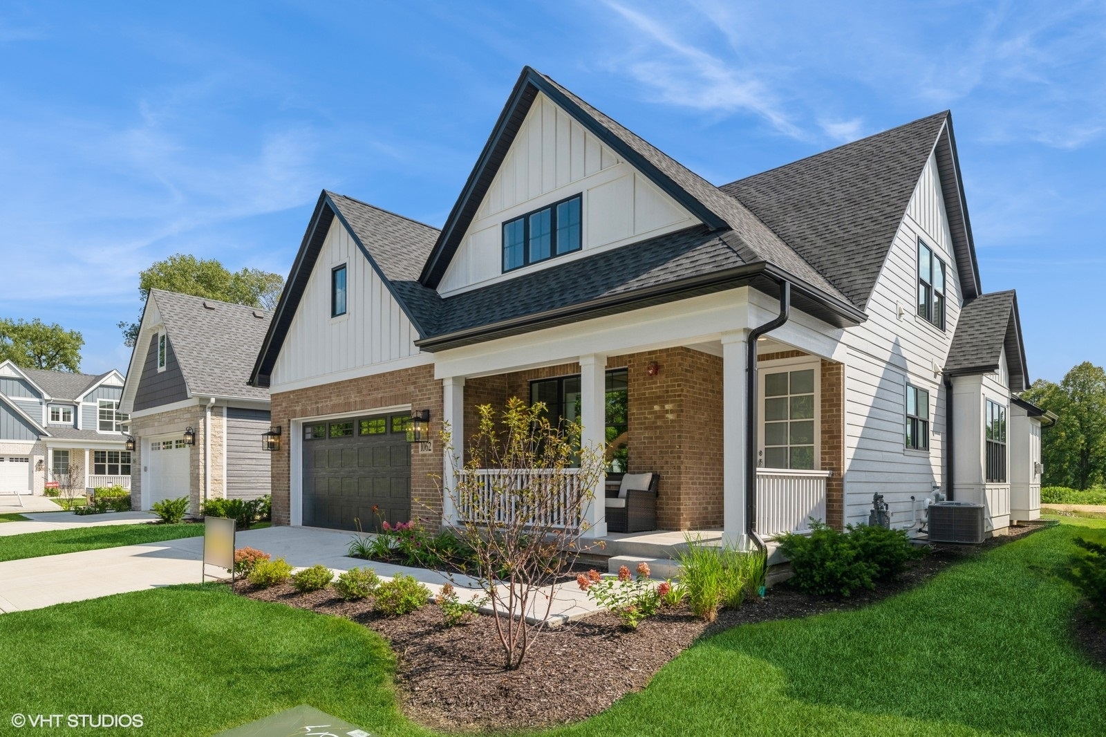 a front view of a house with a yard and porch