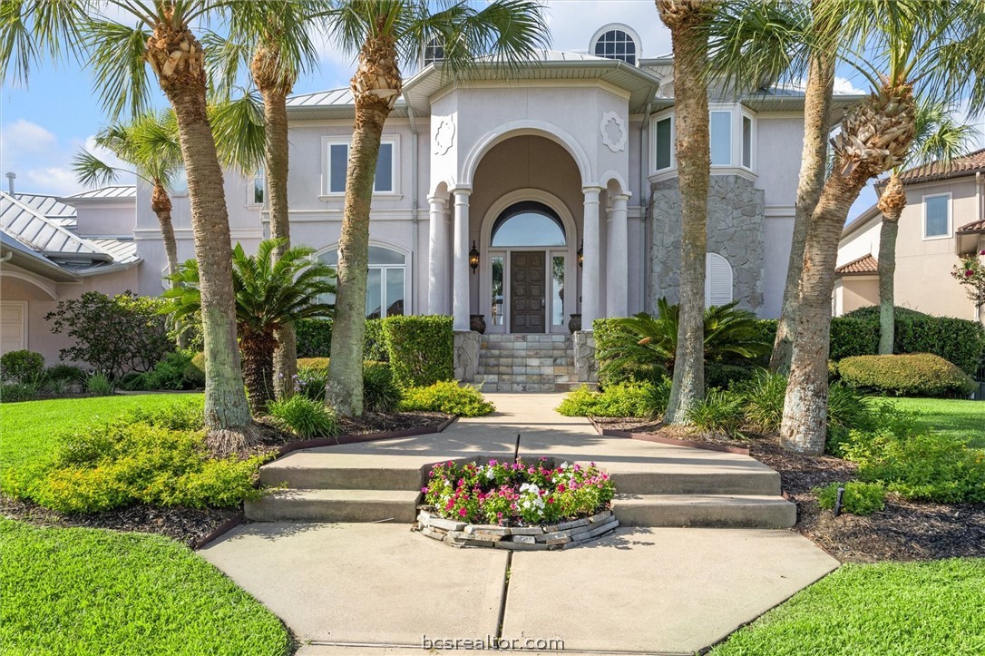 a front view of a house with a garden