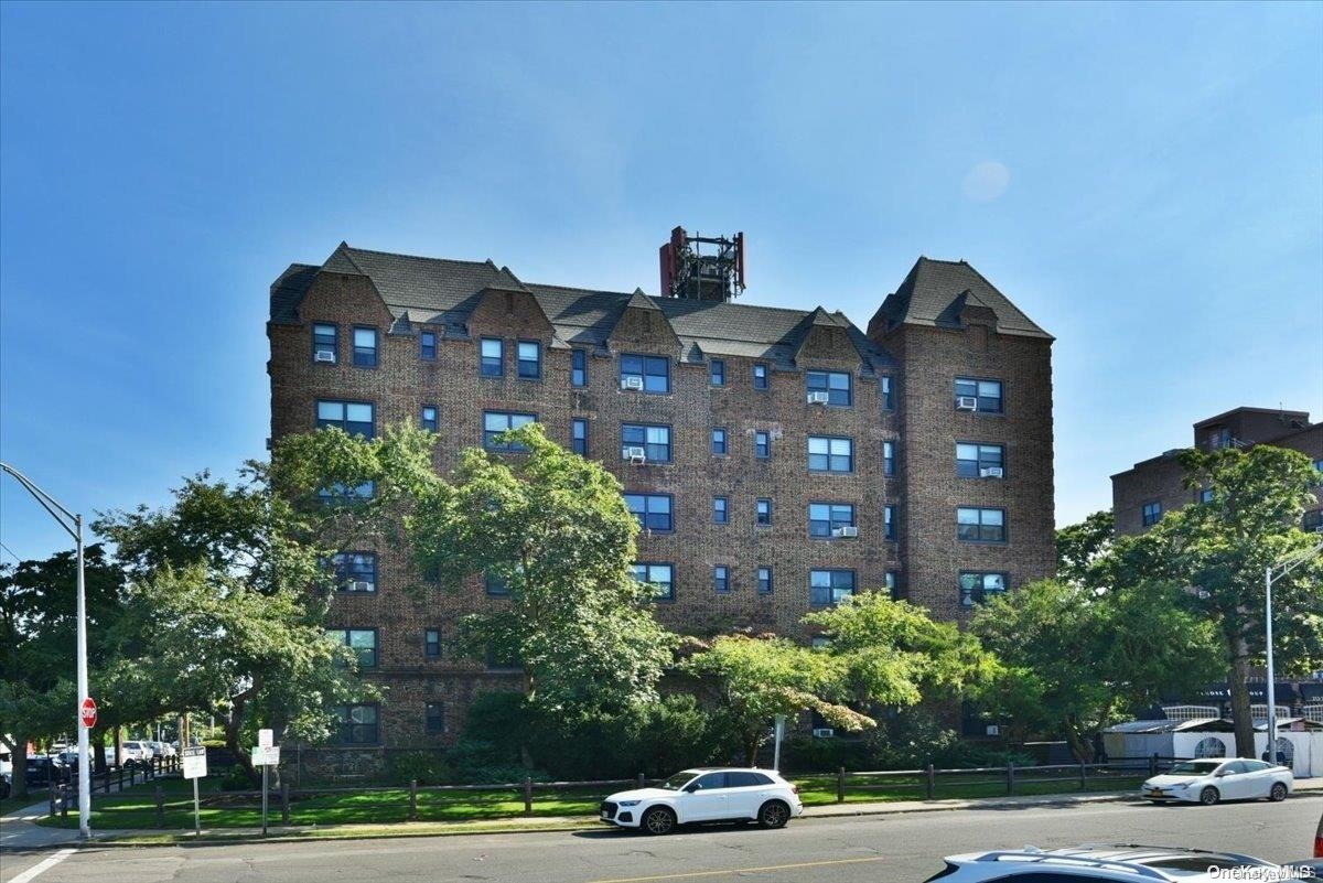 a front view of a building with trees