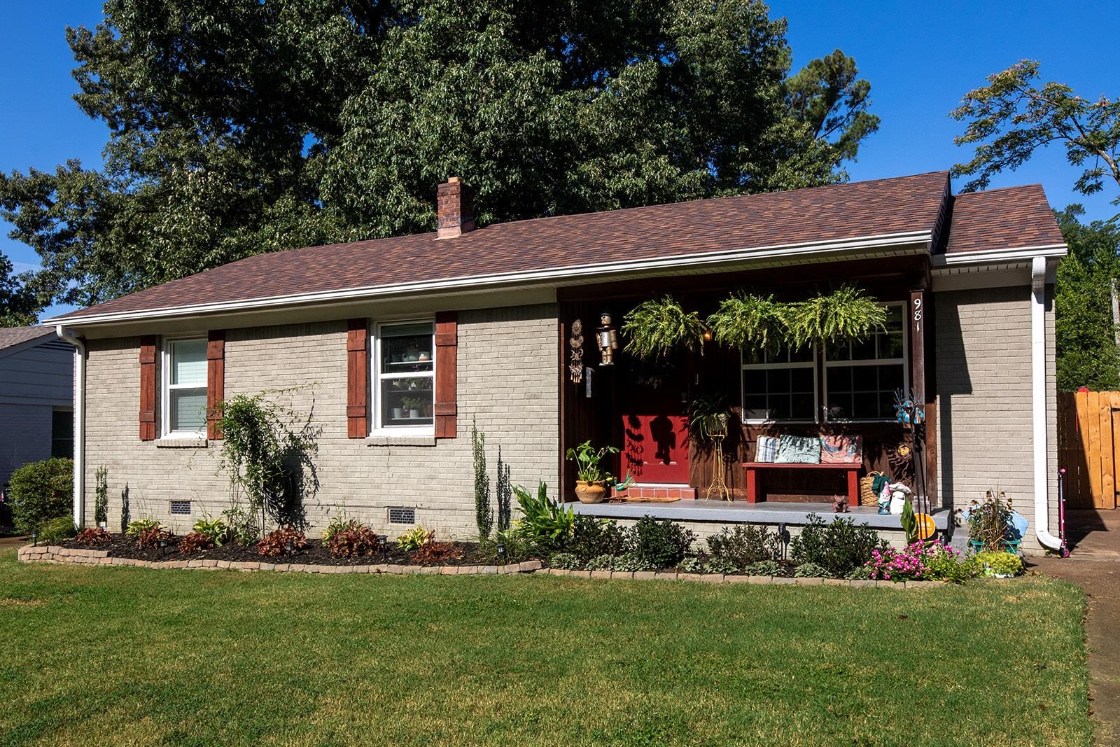 a view of a house with a yard patio and a garden