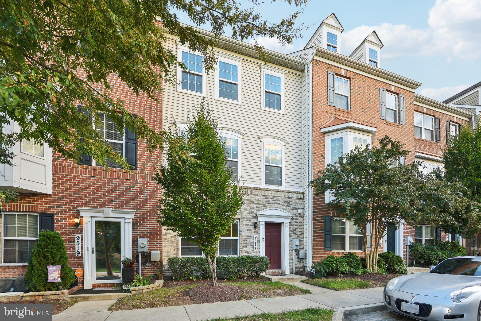 a front view of a multi story residential apartment building with a yard