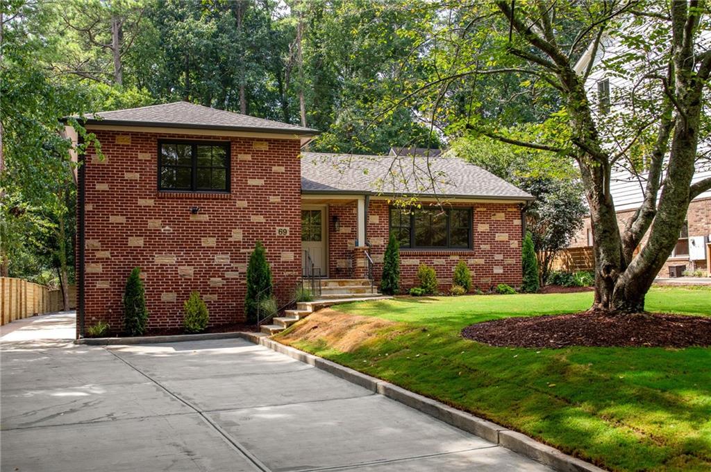 a front view of a house with a garden