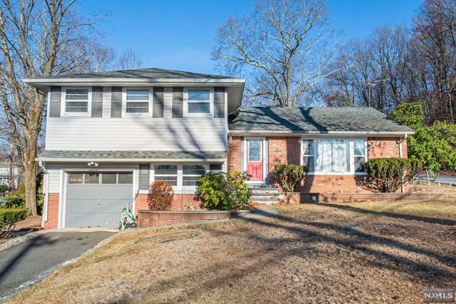 a front view of a house with a yard and glass windows