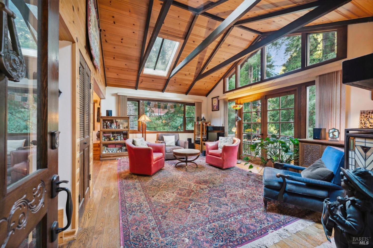 a living room with furniture and floor to ceiling windows