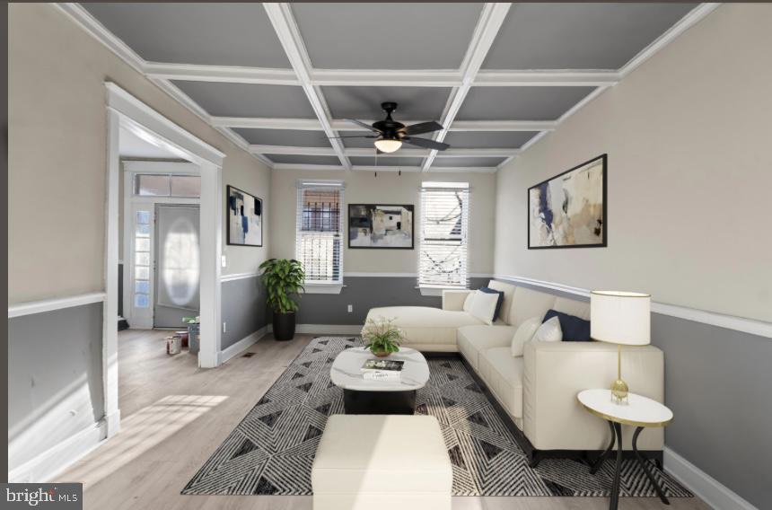 a living room with furniture and view of kitchen