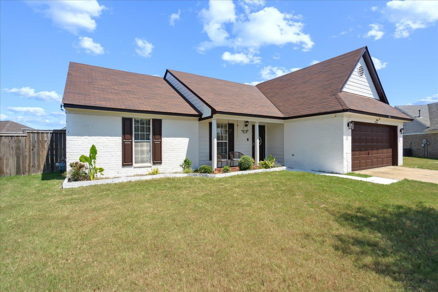 a view of a house with a yard and garage