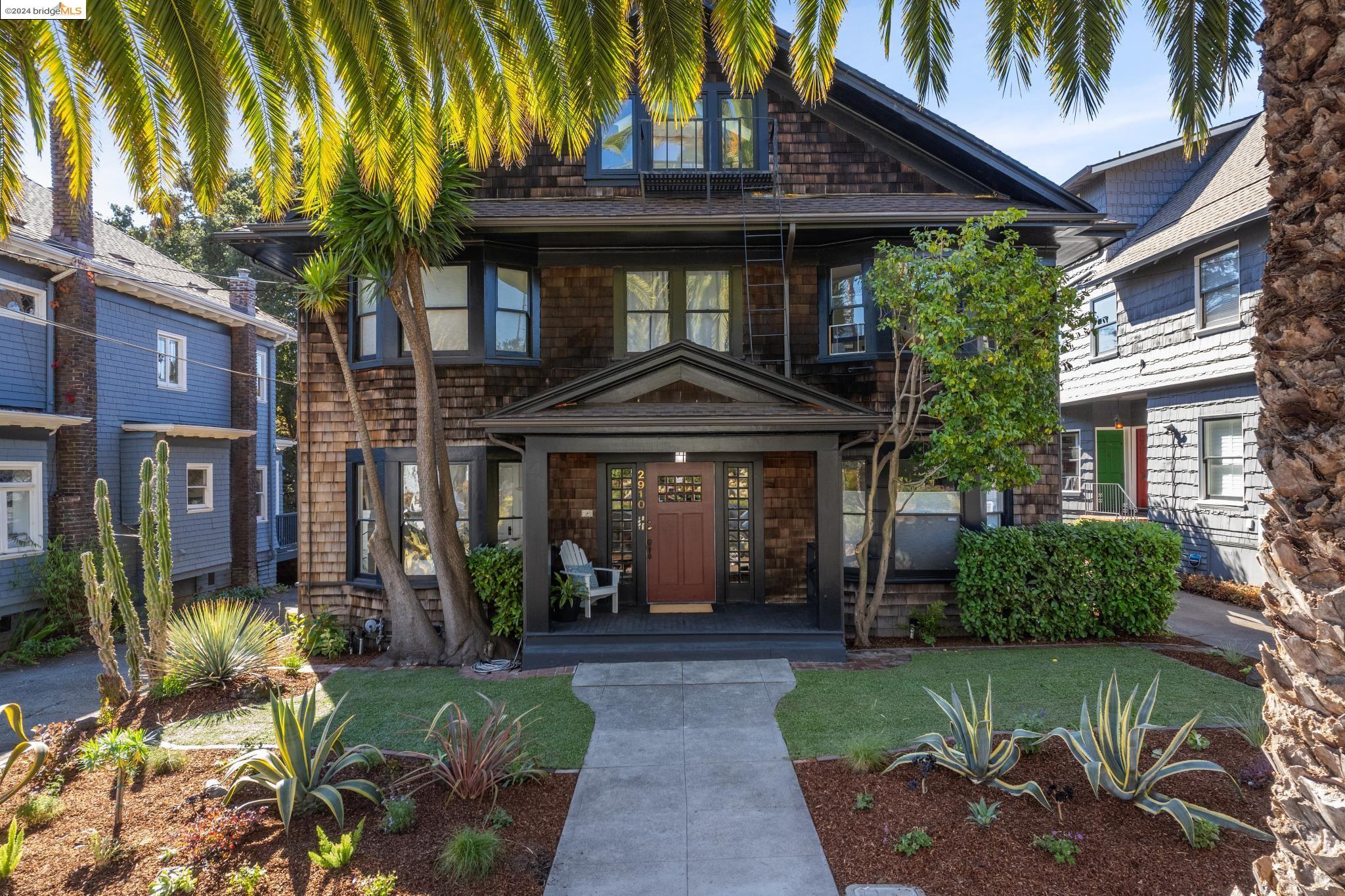 a front view of a house with a garden