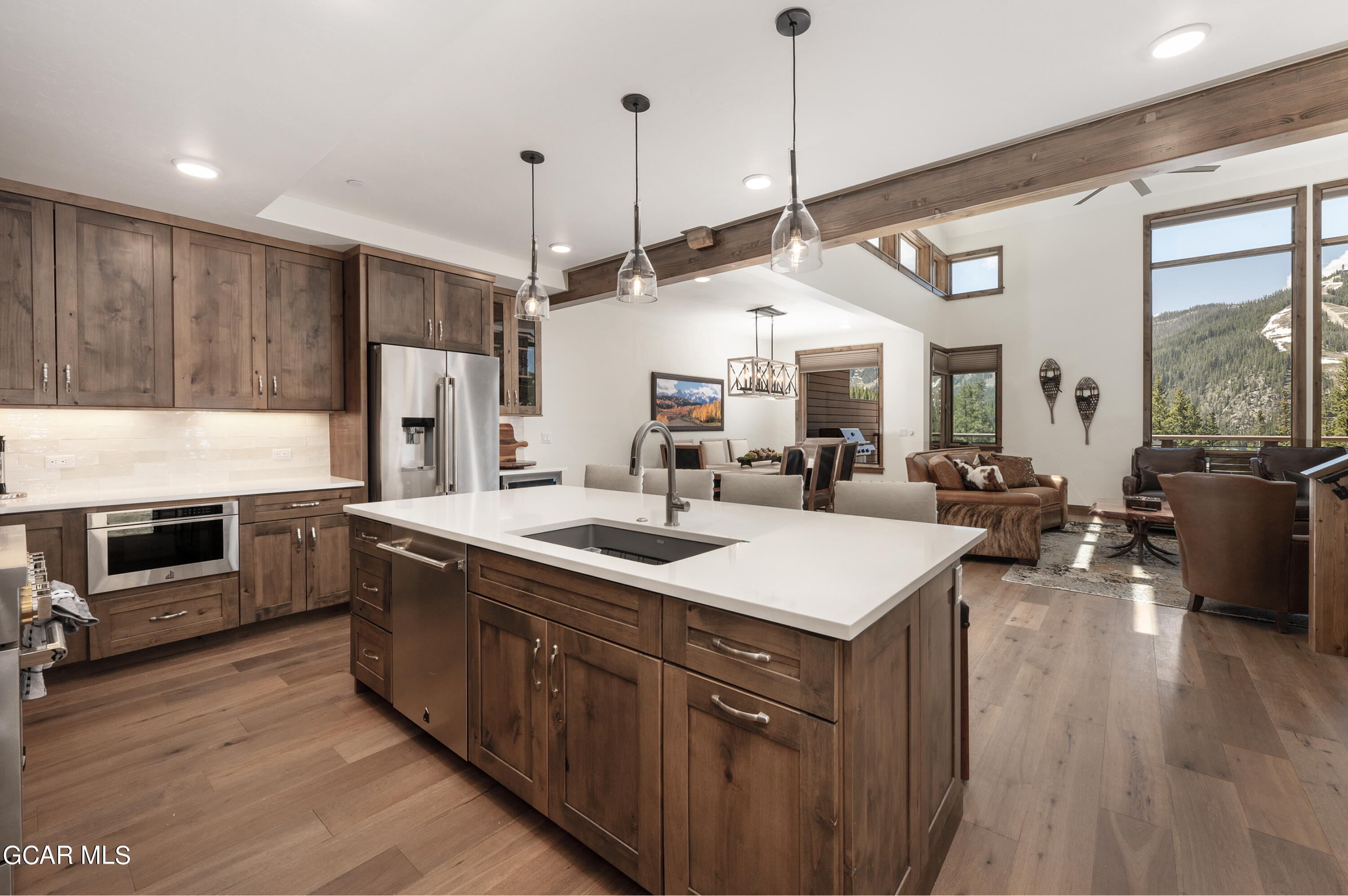 a open kitchen with stainless steel appliances granite countertop a sink a stove and a refrigerator