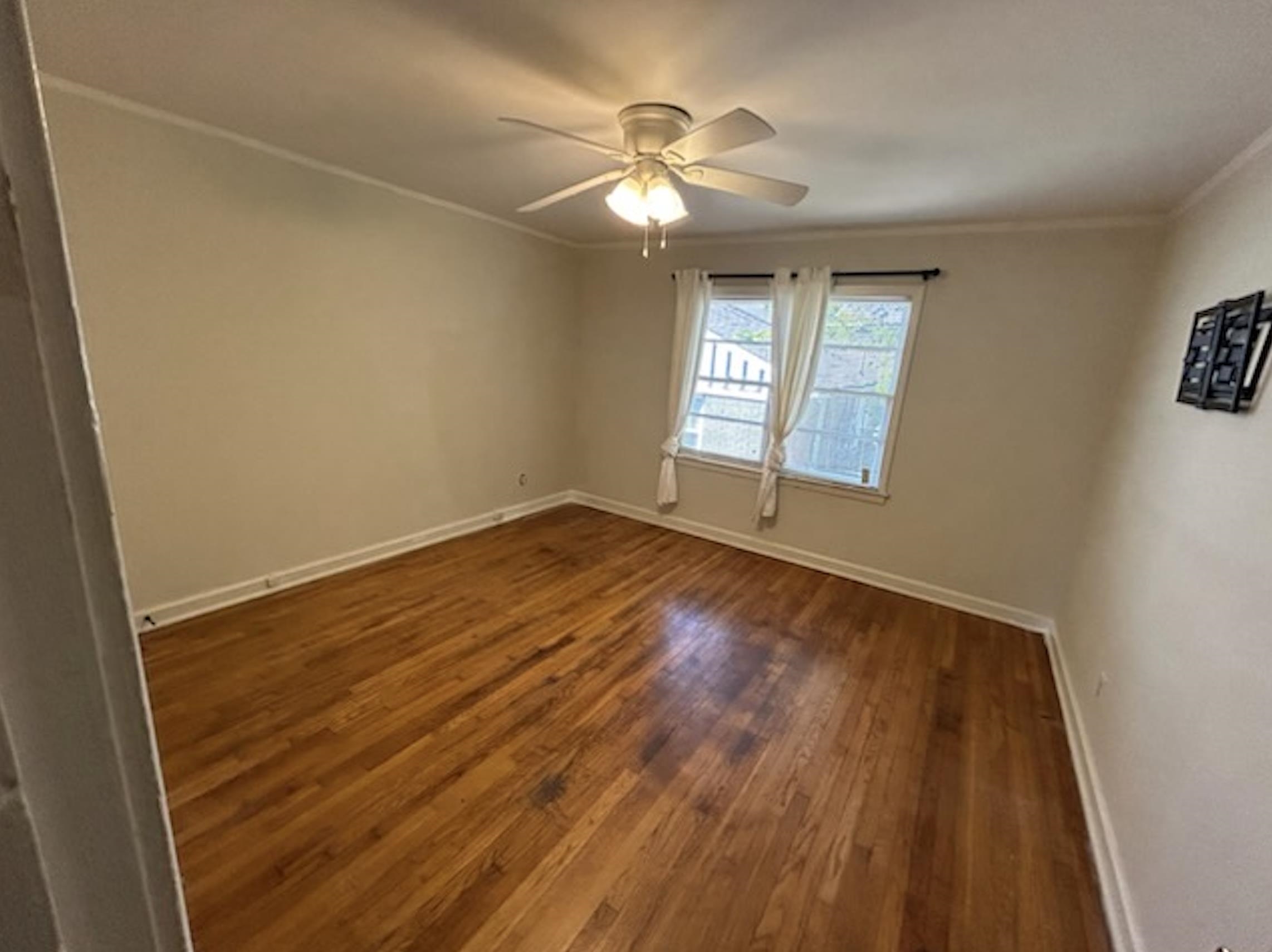 wooden floor in an empty room with a window