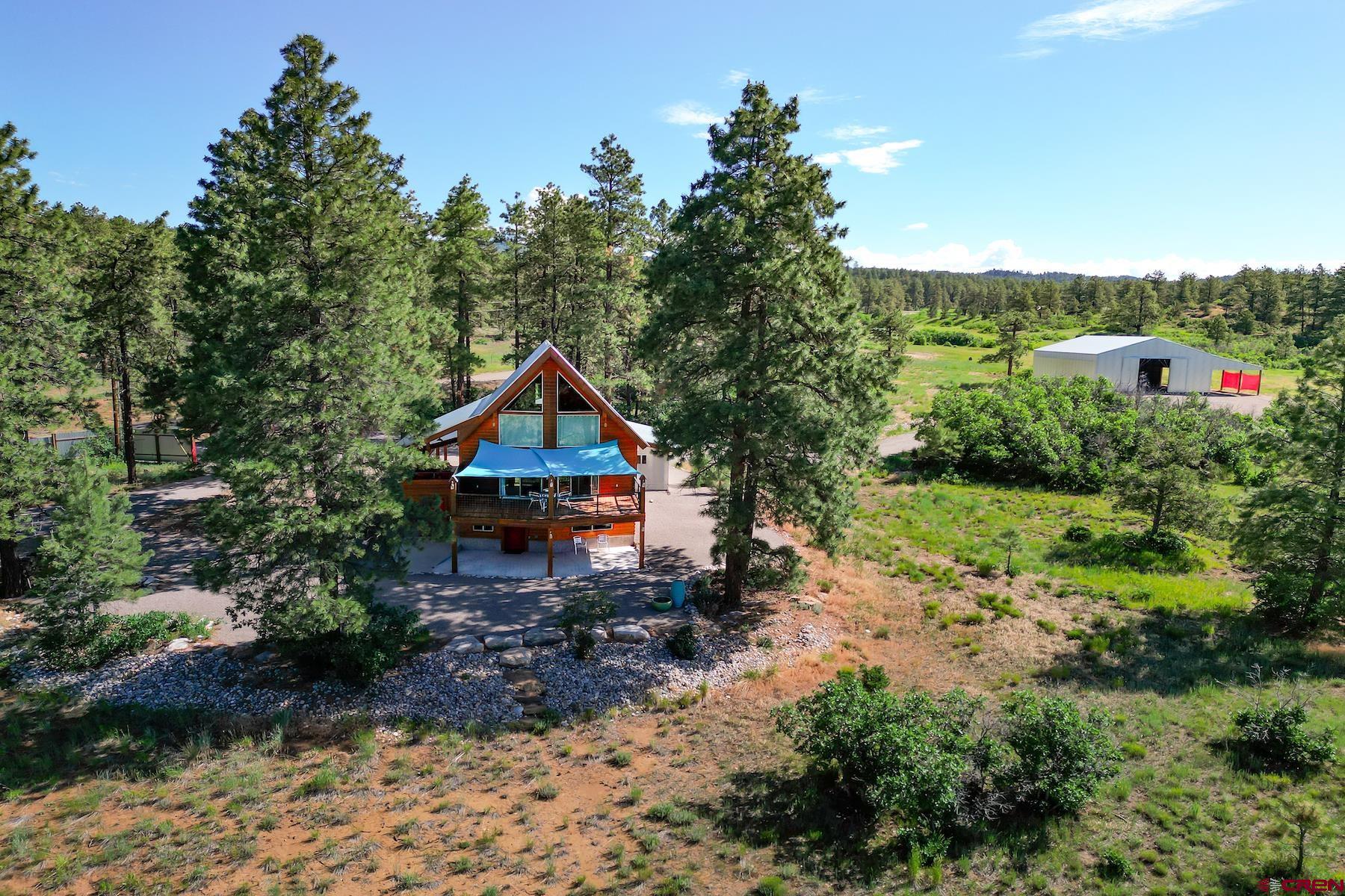 an aerial view of house with yard and outdoor seating