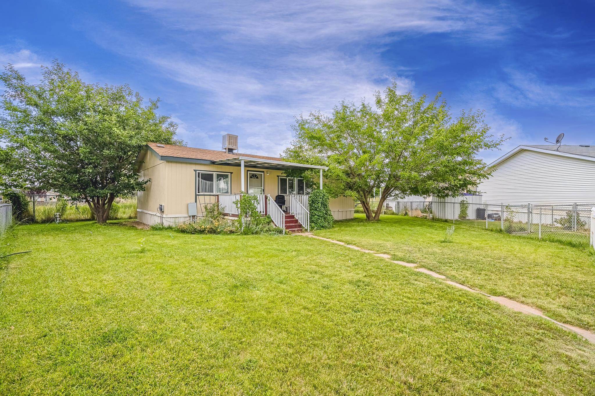 a front view of house with yard and trees