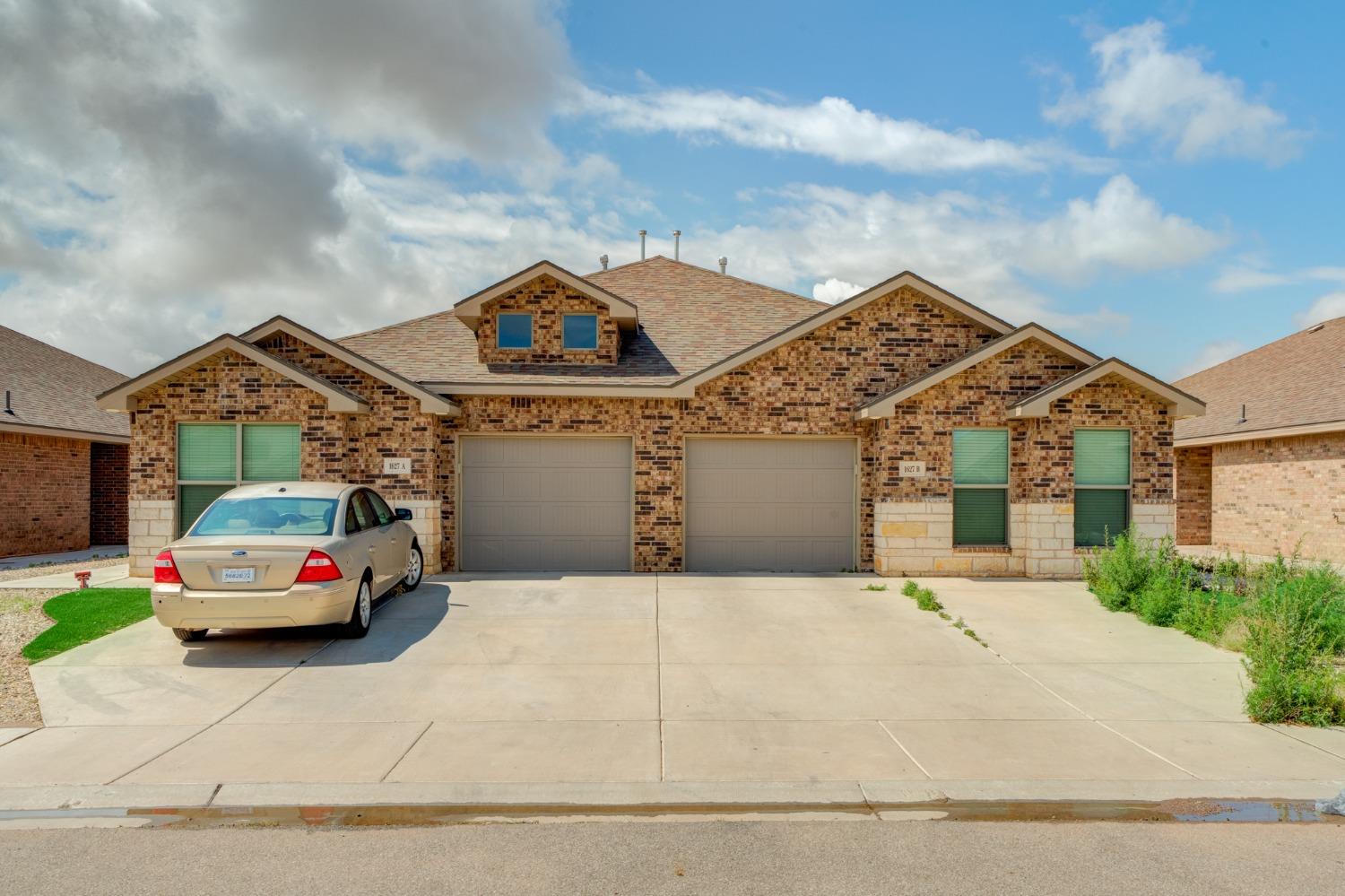 a house with car parked in front of it