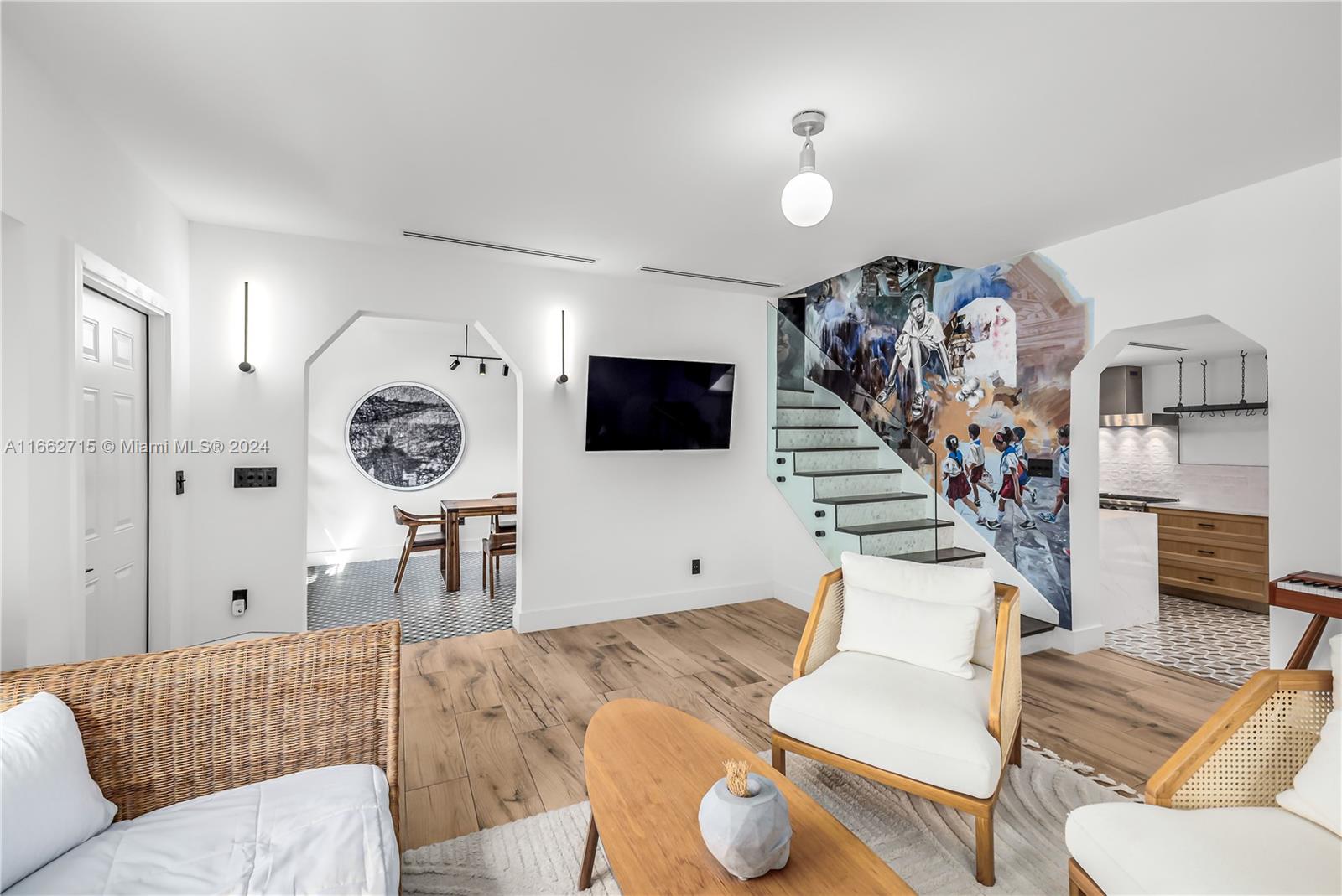 a living room with furniture and a flat screen tv