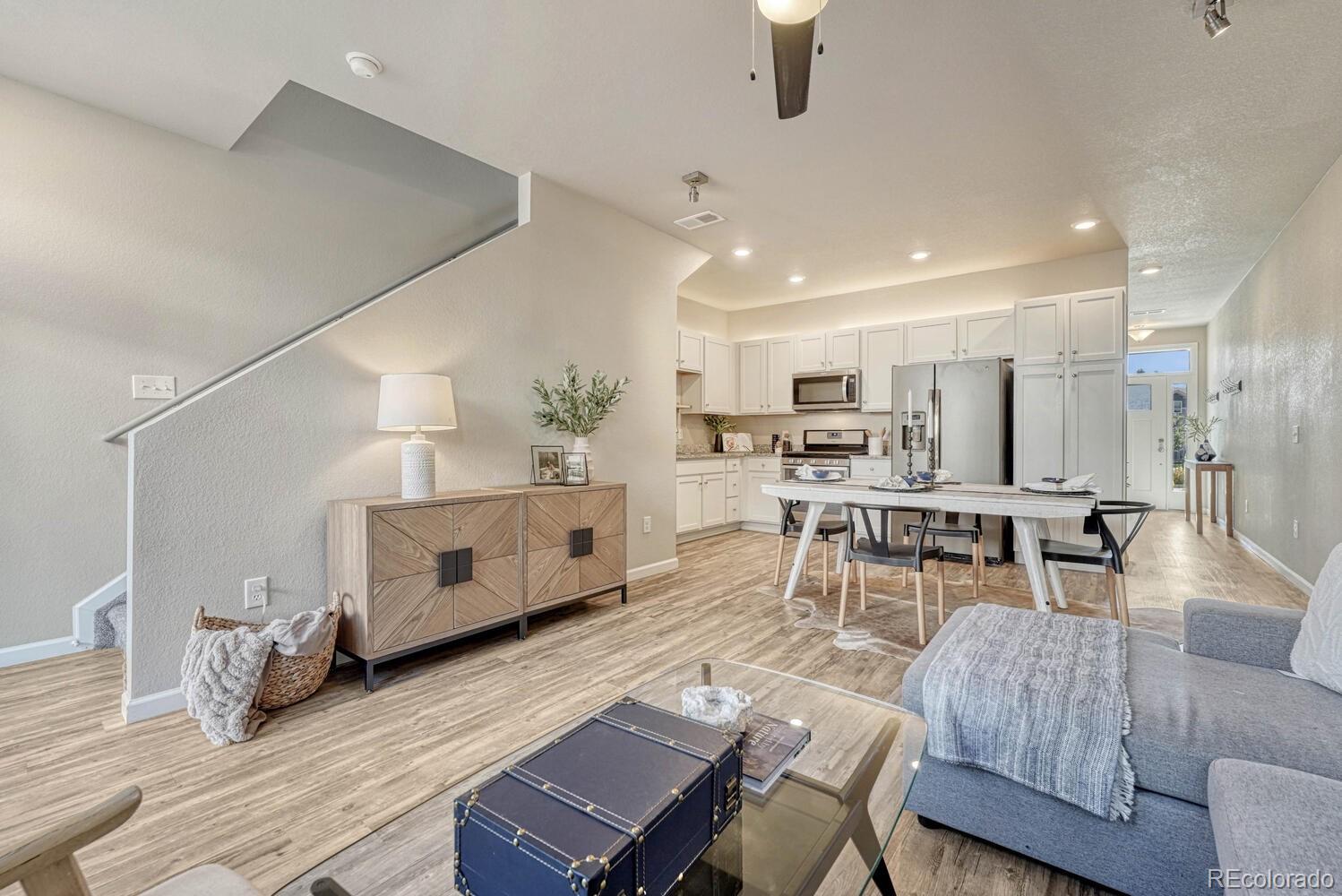 a living room with furniture and kitchen view