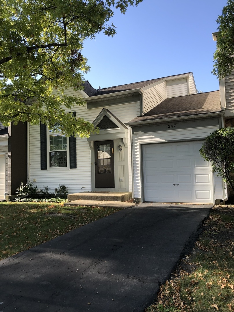 a front view of a house with garage