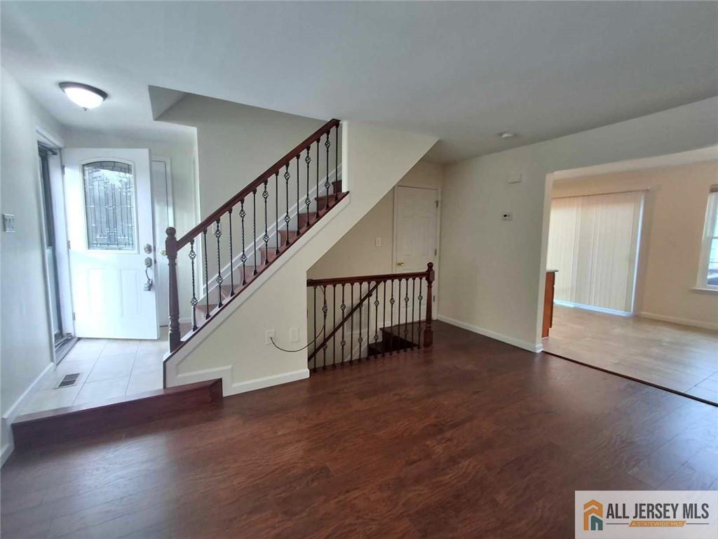 a view of an entryway with wooden floor