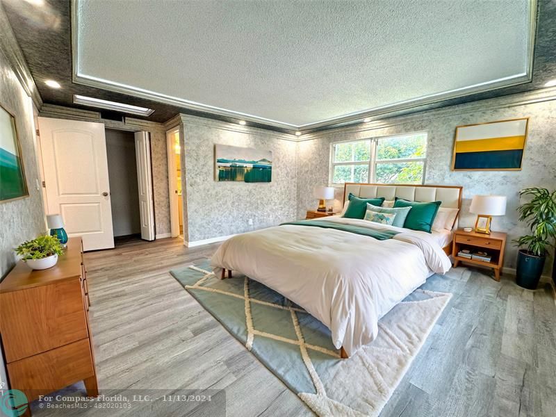 a bedroom with a bed and a potted plant