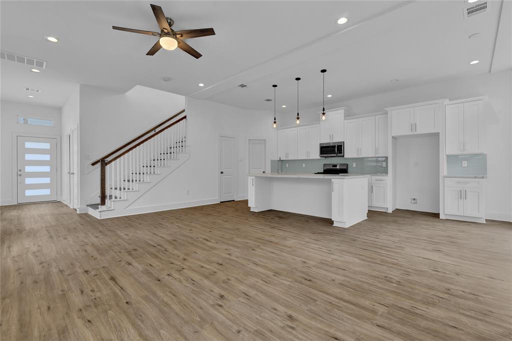 a view of a kitchen with microwave and cabinets