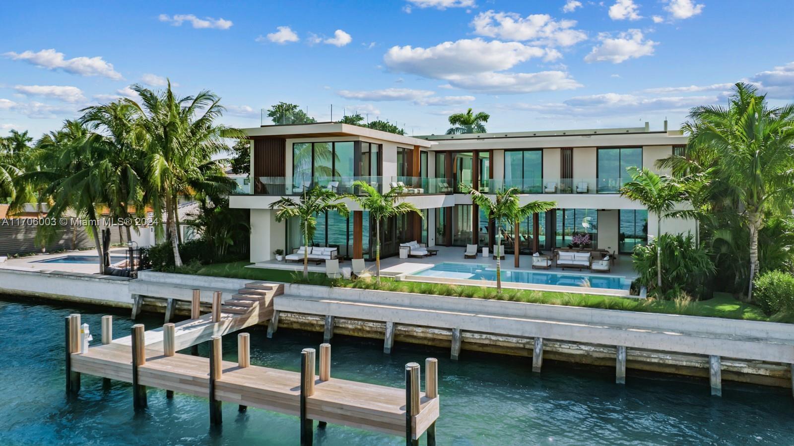 a view of house with swimming pool and outdoor seating