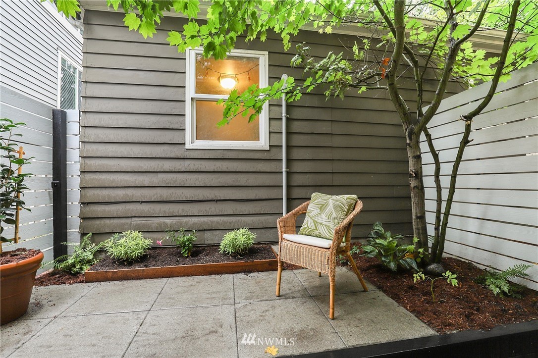 a view of a chair and table in backyard