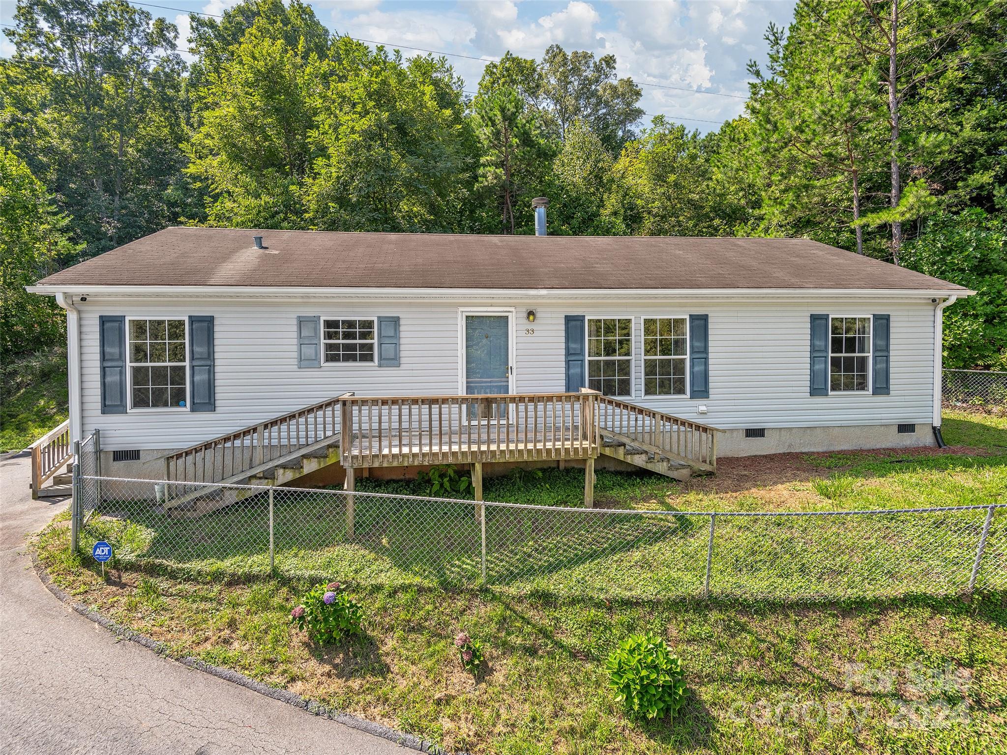 front view of a house with a yard table and chairs