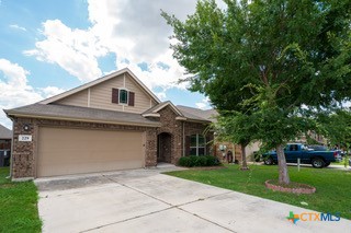 a front view of house with yard and green space