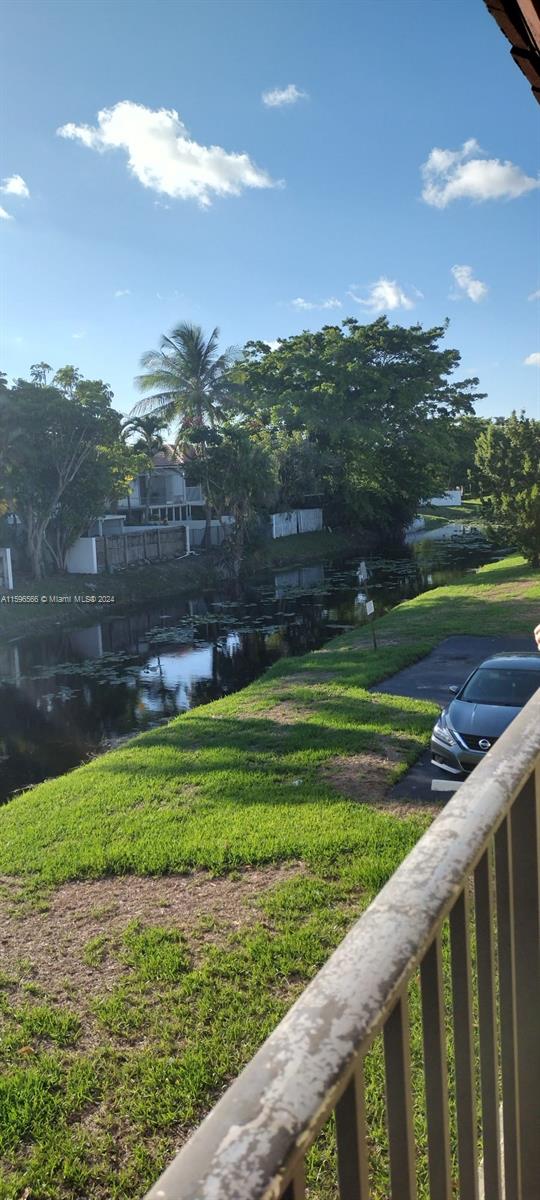 a view of a golf course of a lake with a big yard