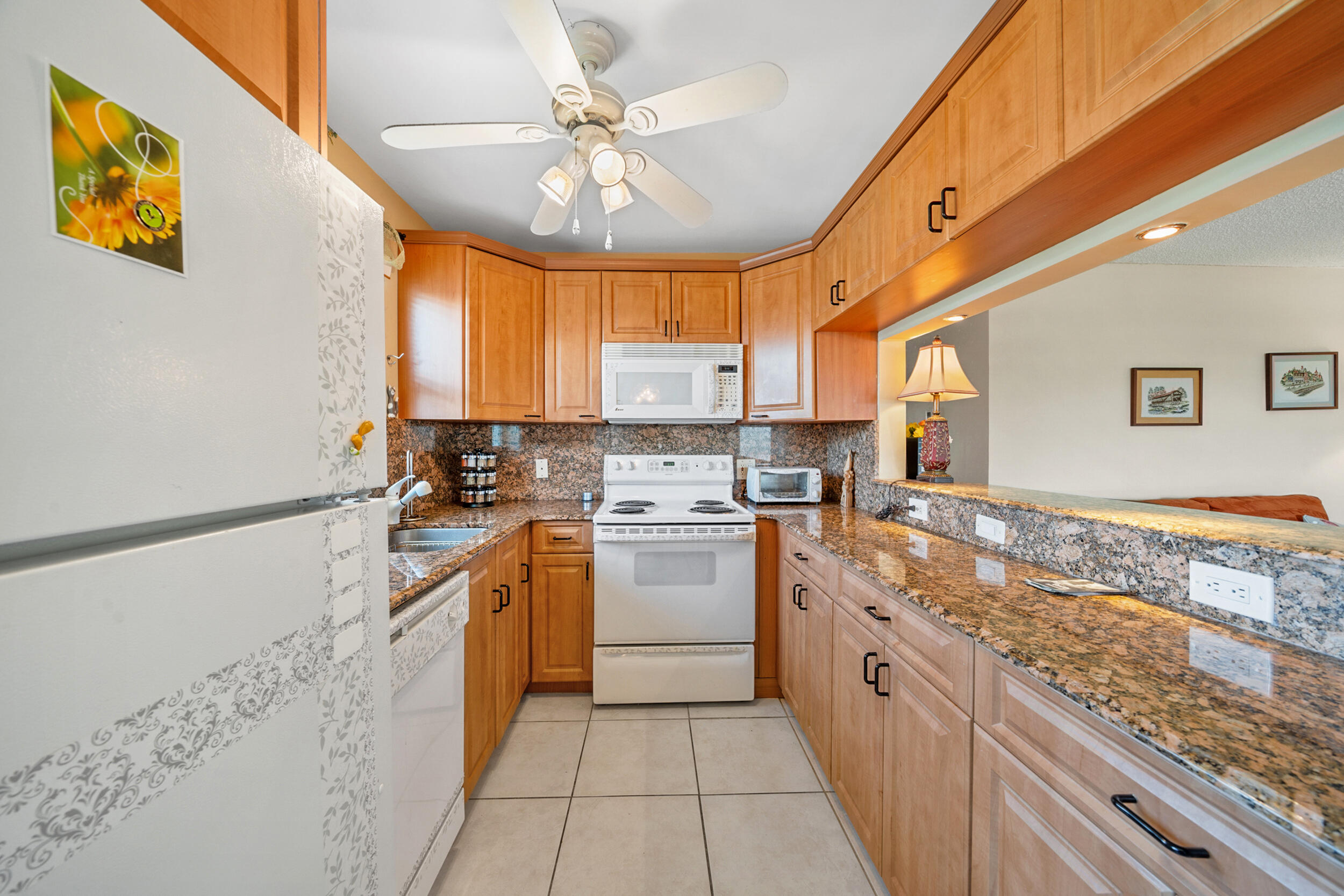 a kitchen with a stove sink and cabinets