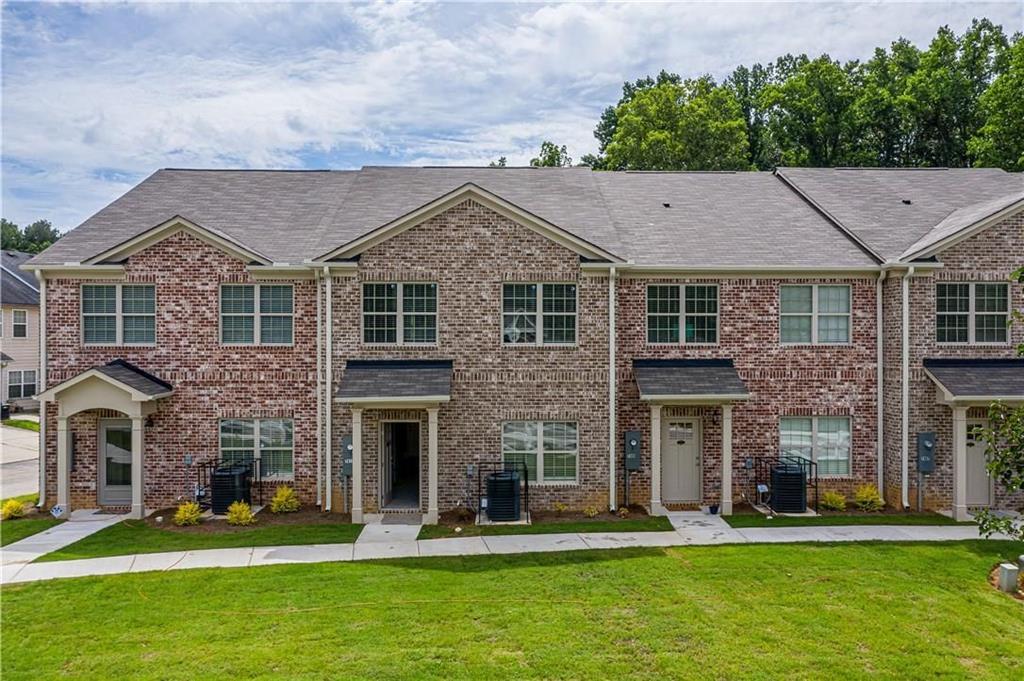 a front view of a house with a yard