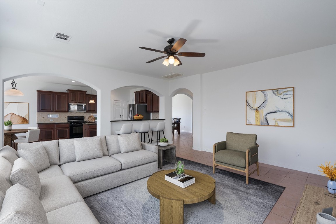 a living room with furniture and kitchen view