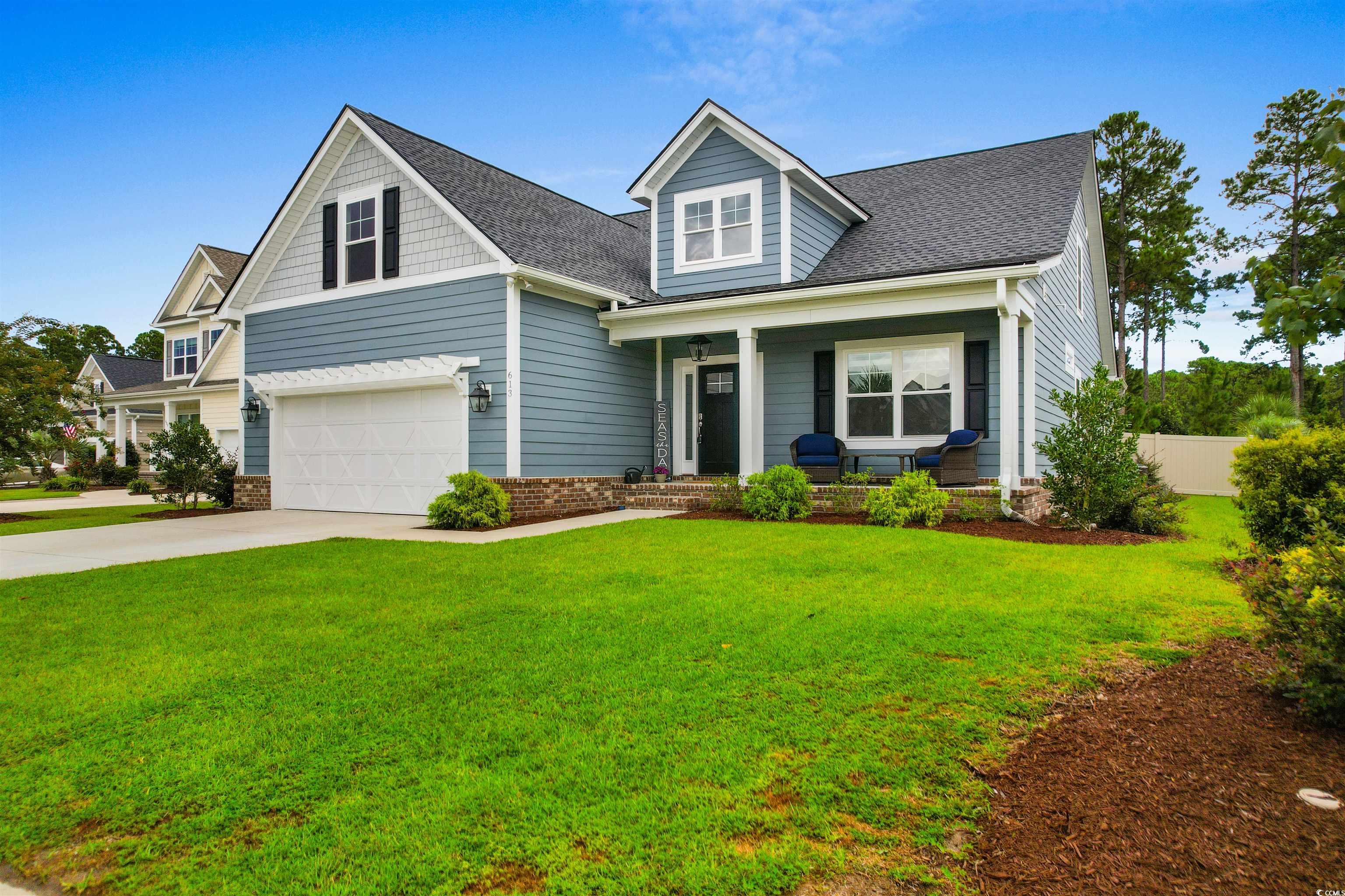 View of front facade with a garage, a front yard,