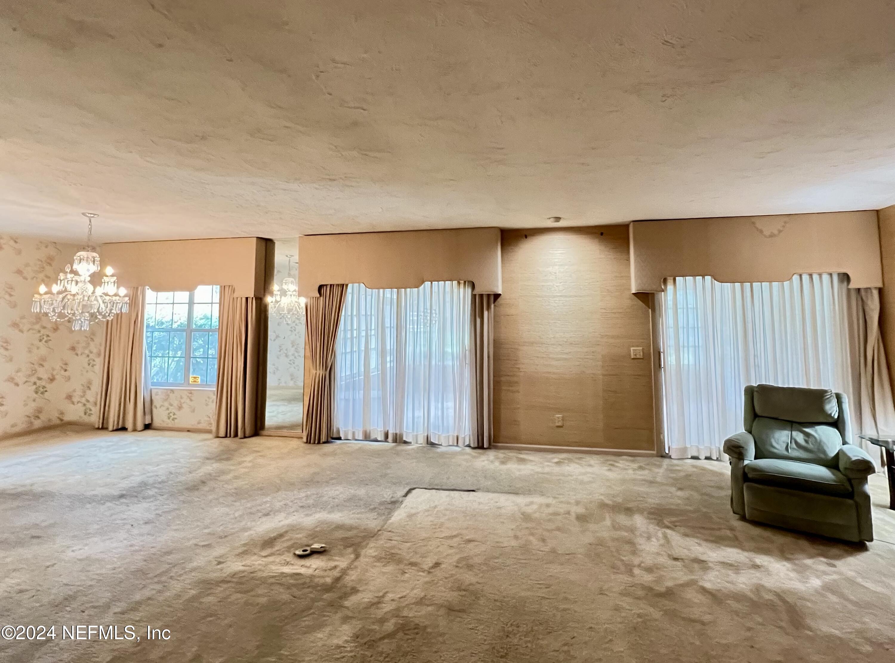 a living room with a couch and a lamp with window