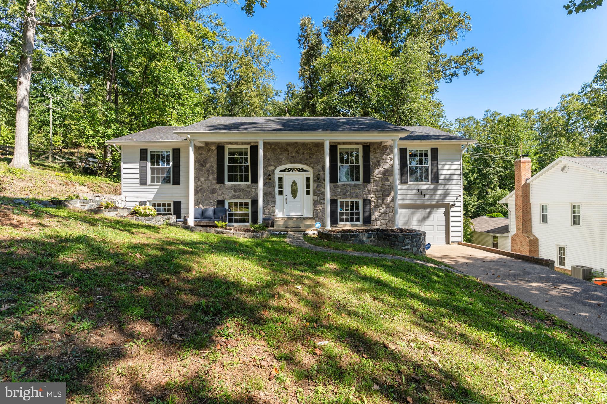 a front view of house with yard and green space