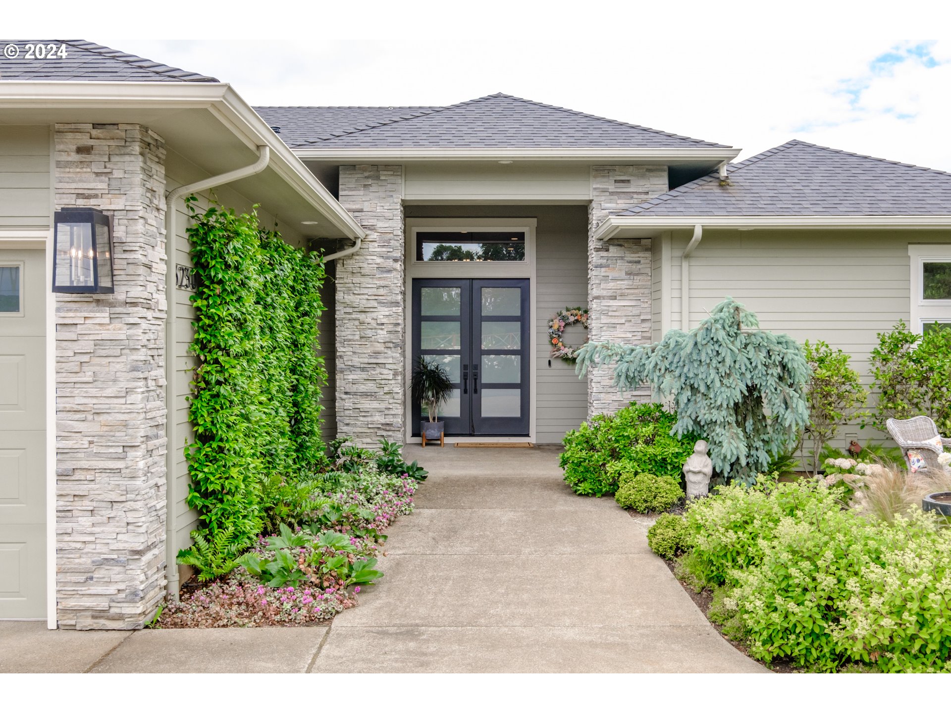 a front view of a house with garden