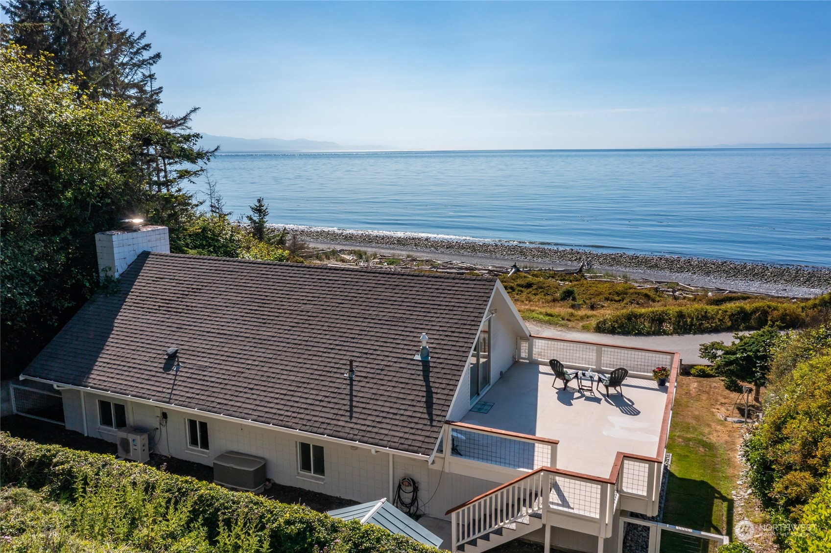 an aerial view of a house with a ocean view