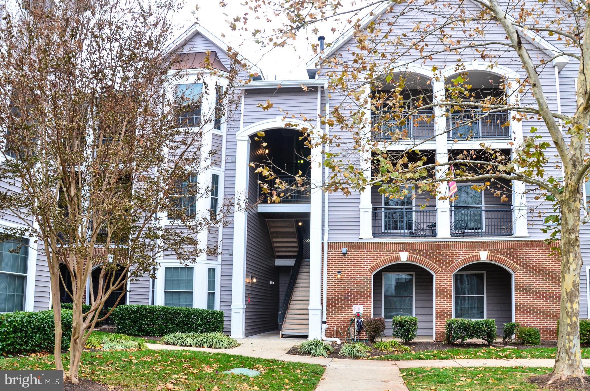 a front view of a building with a yard and garage