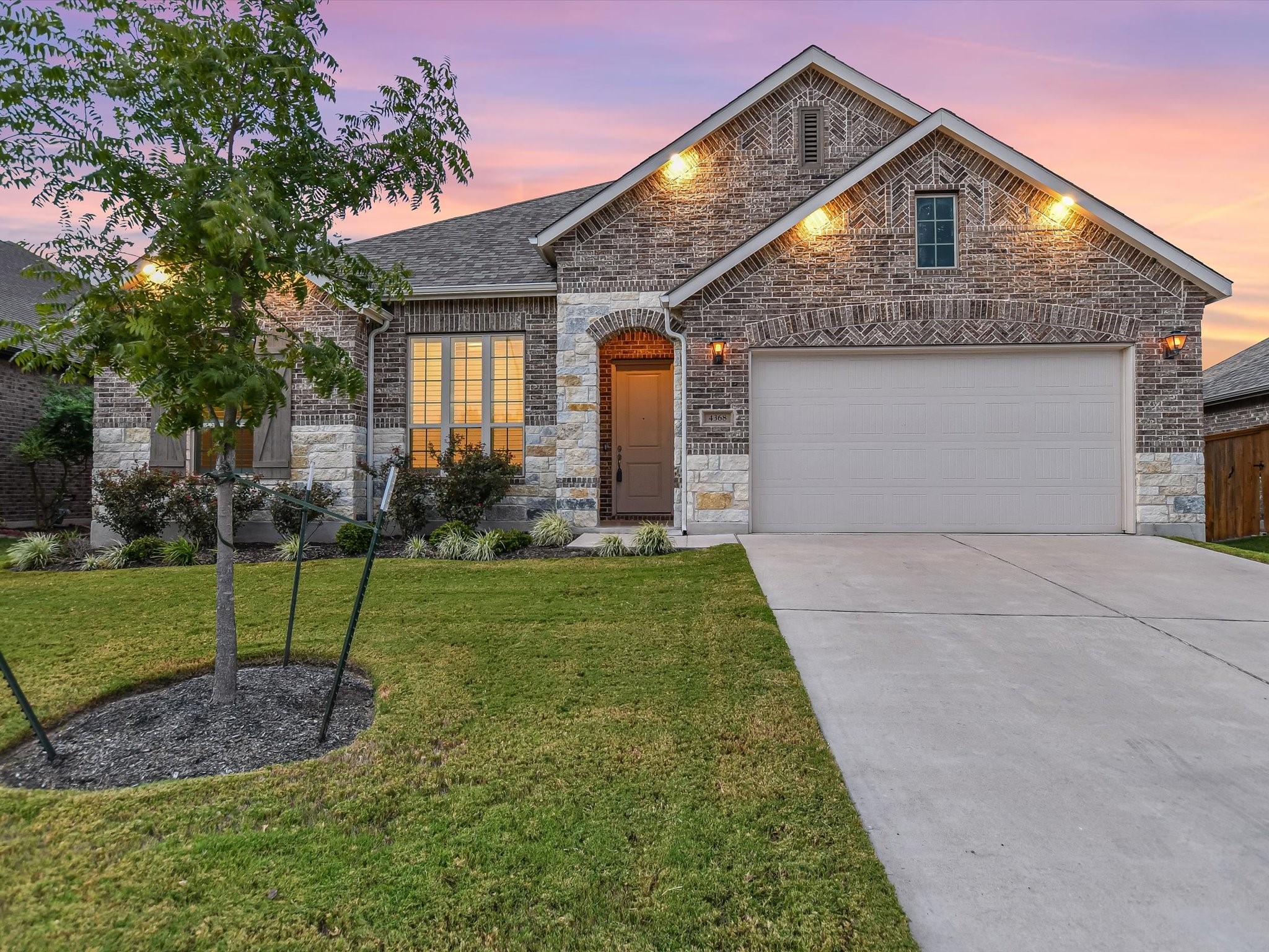 a front view of a house with a yard and outdoor seating