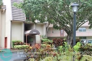 a front view of a house with a yard and fountain