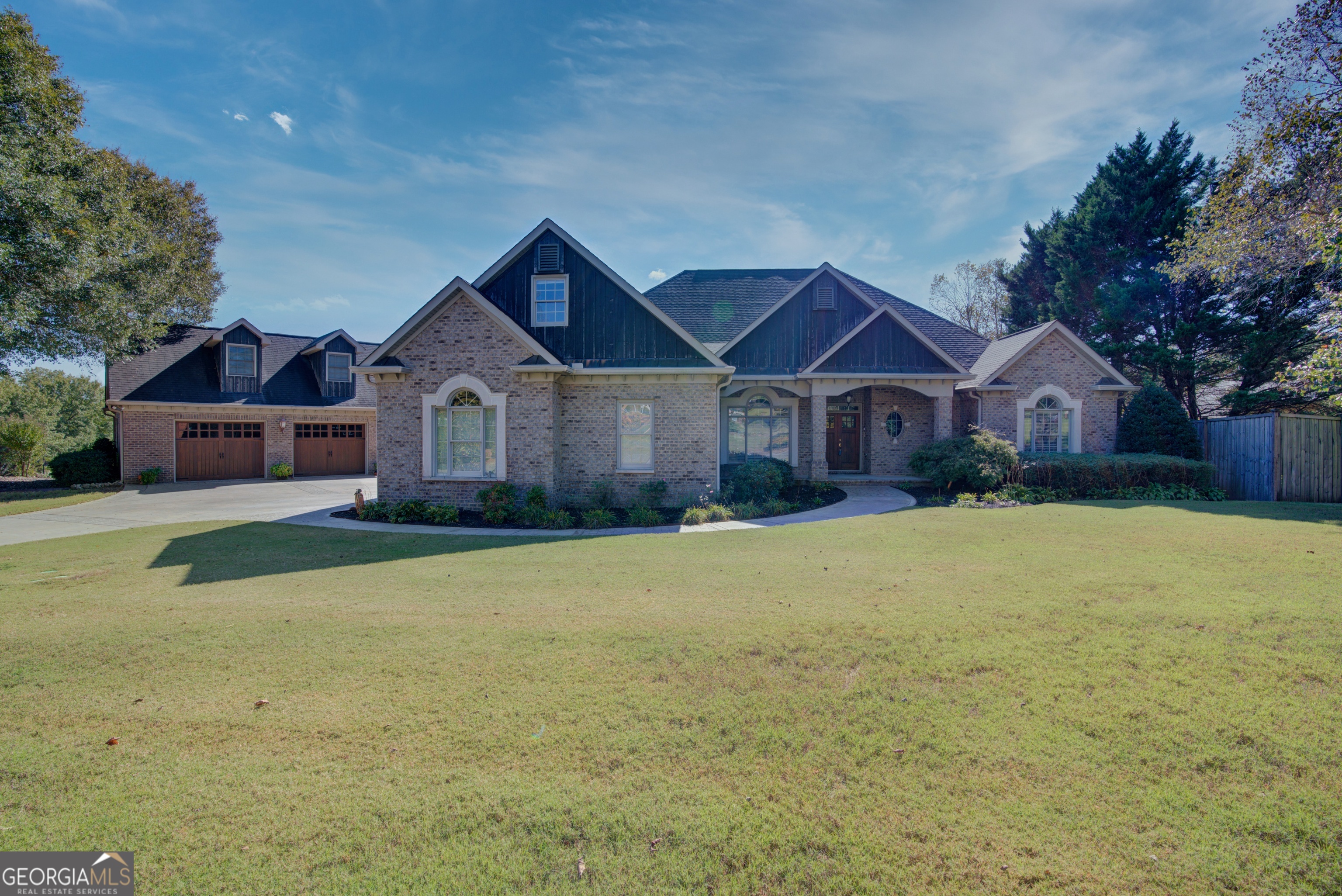 a front view of a house with yard and green space