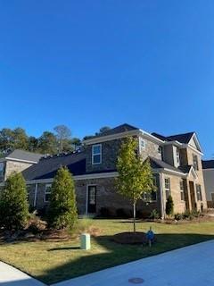 a front view of a house with a yard