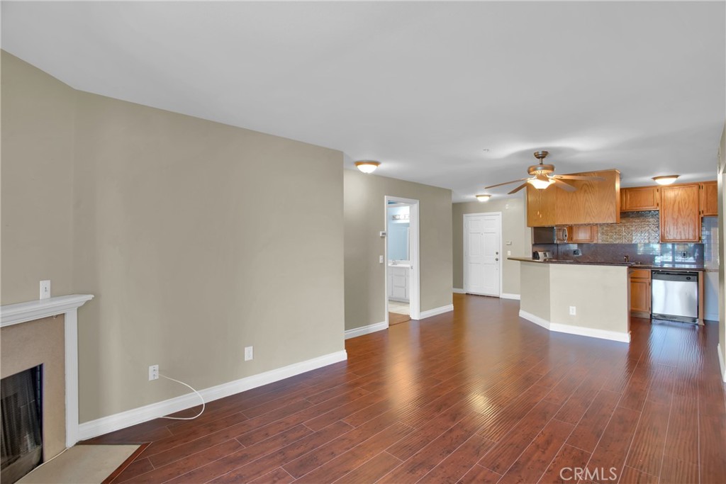 a view of a kitchen with wooden floor and a kitchen