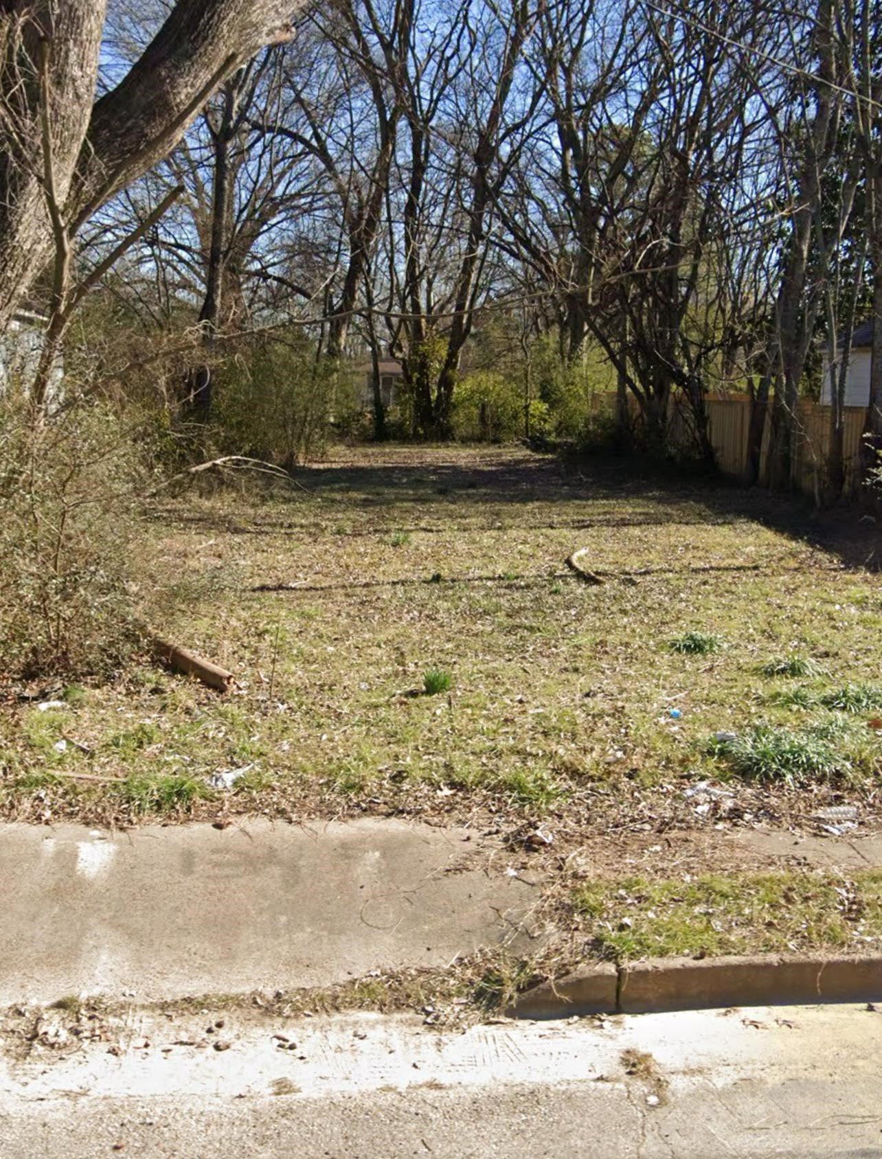 a view of yard with large trees