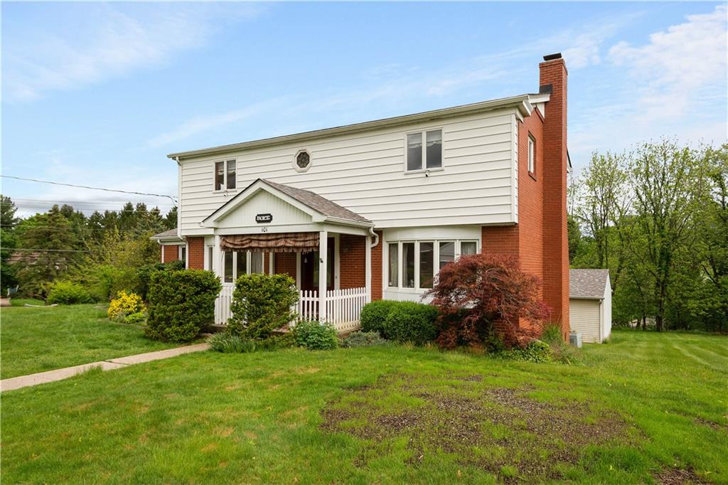 a front view of house with yard and green space