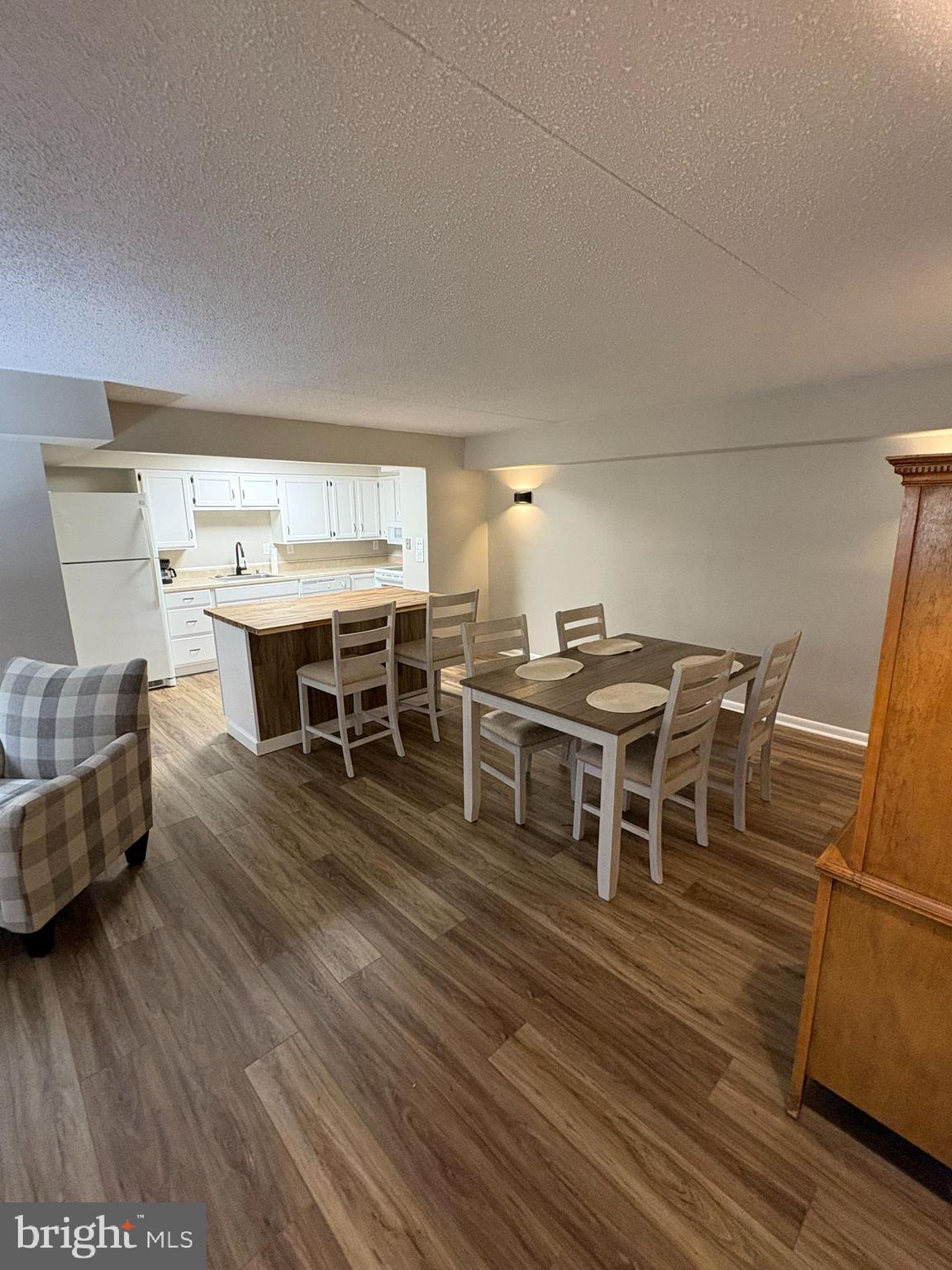 a dining room with furniture wooden floor and a rug