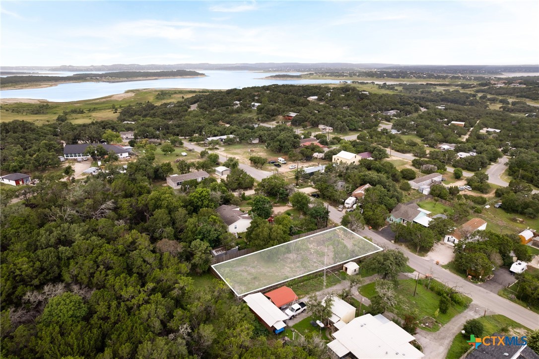 an aerial view of residential houses with outdoor space and ocean view