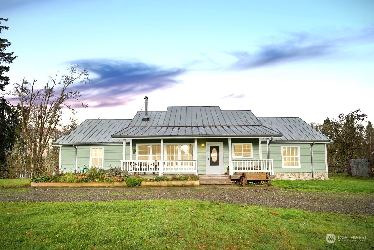 a front view of a house with a garden and patio