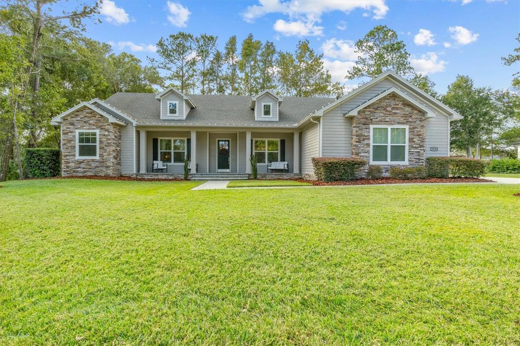 a front view of house with yard and green space